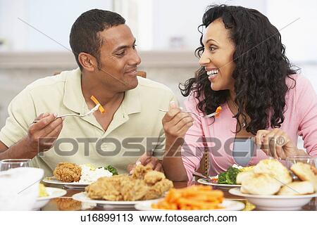 Stock Image - Couple Having Lunch Together At Home. Fotosearch