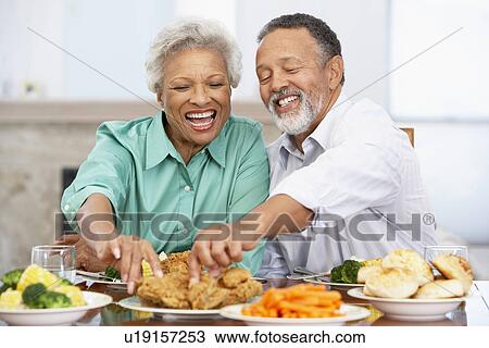 Stock Image - Couple Having Lunch Together At Home. Fotosearch