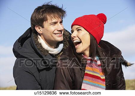 Stock Photograph - Couple Laughing In The Park Together. Fotosearch