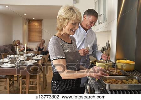Couple Preparing Food For A Dinner Party View Large Photo Image Stock Image - Couple Preparing Food For A Dinner Party. Fotosearch