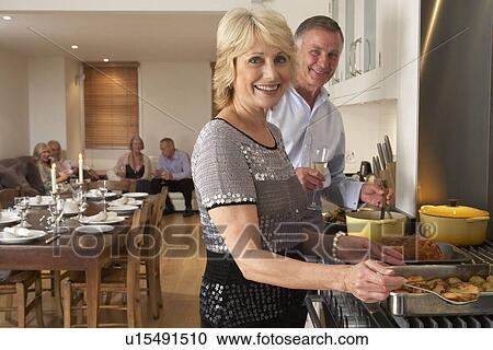 Couple Preparing Food For A Dinner Party View Large Photo Image Stock Image - Couple Preparing Food For A Dinner Party. Fotosearch