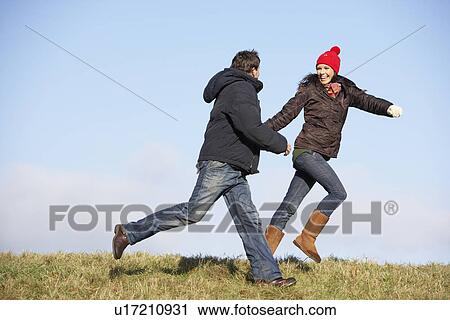 Stock Image - Couple Running In The Park. Fotosearch