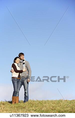 Couple Standing In The Park View Large Photo Image Stock Image - Couple Standing In The Park. Fotosearch