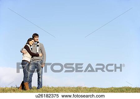Stock Photography - Couple Standing In The Park. Fotosearch