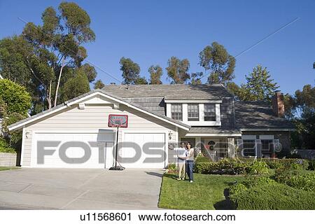 Couple Standing Outside Their House View Large Photo Image Stock Image - Couple Standing Outside Their House. Fotosearch