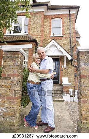 Couple Standing Outside Their House View Large Photo Image Stock Photo - Couple Standing Outside Their House. Fotosearch