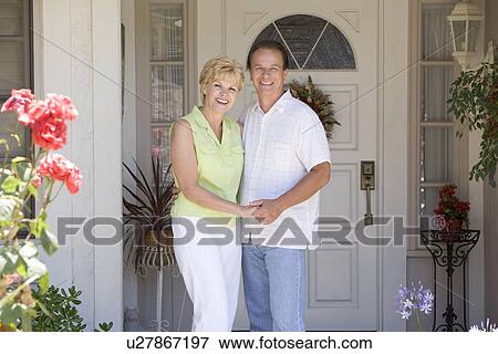 Couple Standing Outside Their House View Large Photo Image Stock Photo - Couple Standing Outside Their House. Fotosearch