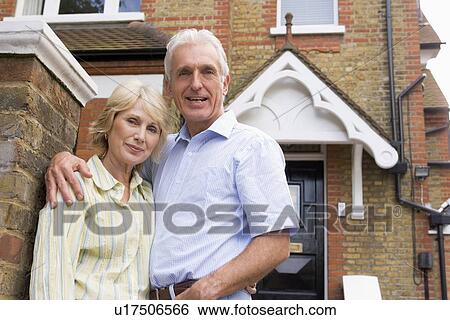 Couple Standing Outside Their House View Large Photo Image Stock Photograph - Couple Standing Outside Their House. Fotosearch