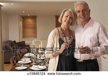 Picture - Couple Throwing A Dinner Party. Fotosearch