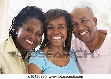 Stock Image - Couple With Their Teenage Daughter. Fotosearch