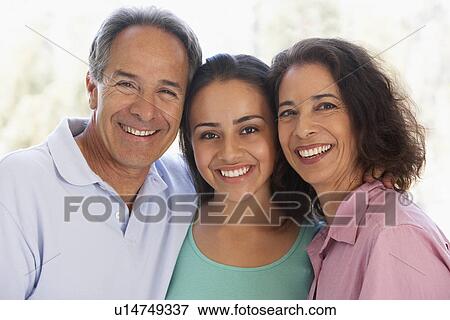 Stock Photo - Couple With Their Teenage Daughter. Fotosearch