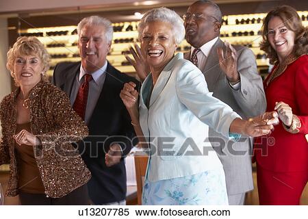 Stock Photography - Couples Dancing Together At A Nightclub. Fotosearch