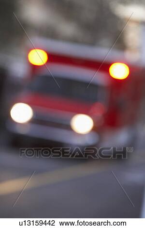 Defocused shot of ambulance on a city street View Large Photo Image Stock Image - Defocused shot of ambulance on a city street. Fotosearch