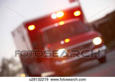 Stock Photo - Defocused shot of ambulance on a city street. Fotosearch