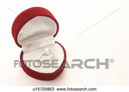 Stock Image - Diamond Engagement In Heart Shaped Ring Box. Fotosearch