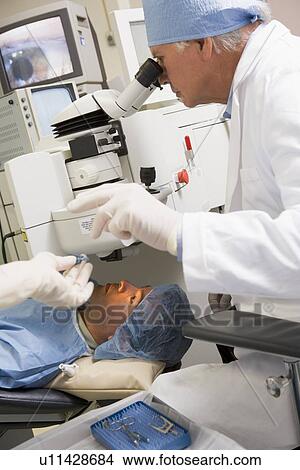 Picture - Doctor Checking Patient's Eyes. Fotosearch