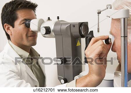 Stock Image - Doctor Checking Patient's Eyes. Fotosearch