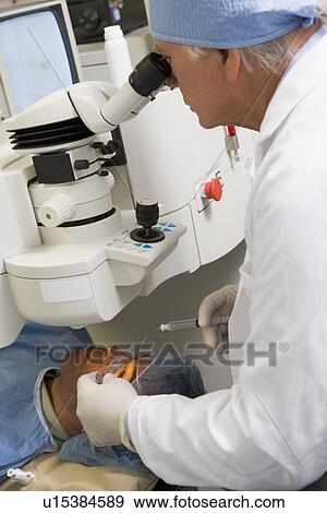 Stock Photo - Doctor Checking Patient's Eyes. Fotosearch