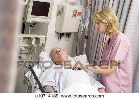 Stock Photo - Doctor Checking Patient's Heartbeat. Fotosearch