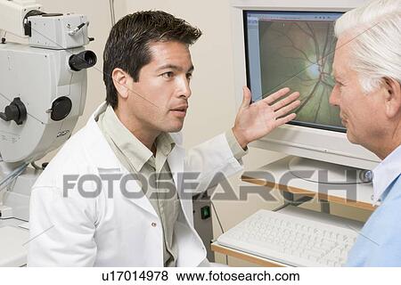 Doctor Explaining Eye Exam Results To Patient View Large Photo Image Stock Photo - Doctor Explaining Eye Exam Results To Patient. Fotosearch