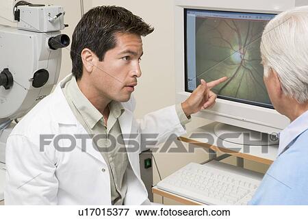 Stock Photo - Doctor Explaining Eye Exam Results To Patient. Fotosearch