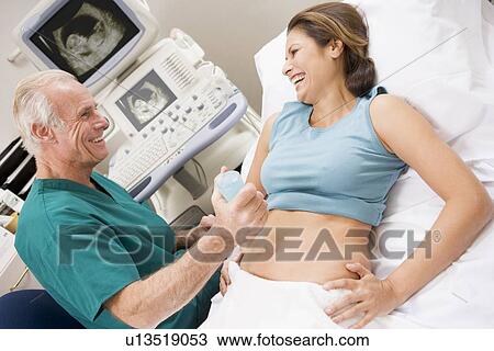 Stock Image - Doctor Giving Patient An Ultra Sound . Fotosearch