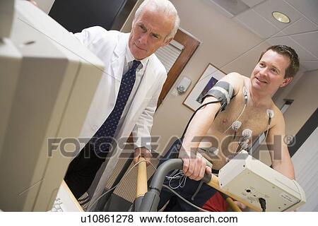 Stock Photo - Doctor Monitoring Patient During Health Check. Fotosearch
