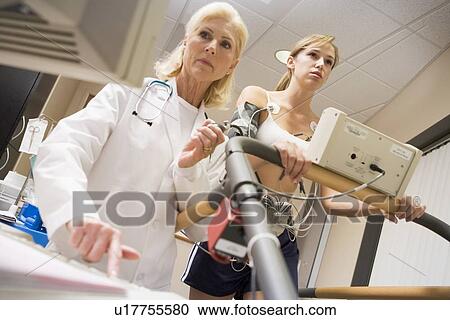 Doctor Monitoring The Heart-Rate Of Patient On A Treadmill View Large Photo Image Stock Image - Doctor Monitoring The Heart-Rate Of Patient On A Treadmill. Fotosearch