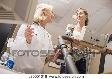 Doctor Monitoring The Heart-Rate Of Patient On A Treadmill View Large Photo Image Stock Photo - Doctor Monitoring The Heart-Rate Of Patient On A Treadmill. Fotosearch
