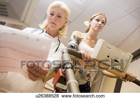 Doctor Monitoring The Heart-Rate Of Patient On A Treadmill View Large Photo Image Stock Photo - Doctor Monitoring The Heart-Rate Of Patient On A Treadmill. Fotosearch
