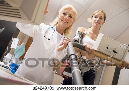 Doctor Monitoring The Heart-Rate Of Patient On A Treadmill View Large Photo Image Stock Photography - Doctor Monitoring The Heart-Rate Of Patient On A Treadmill. Fotosearch