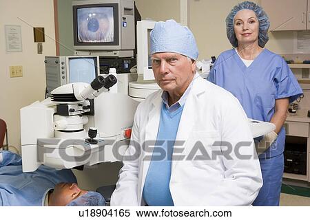 Stock Photography - Doctor, Nurse And Patient About To Undergo Eye Exam. Fotosearch