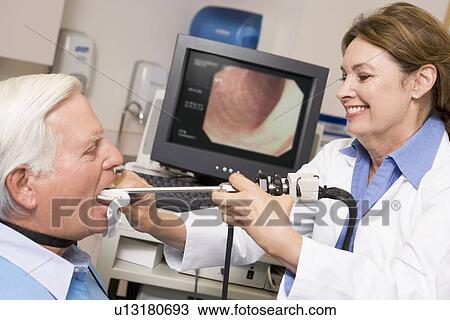 Stock Image - Doctor Performing Check-Up On Patient. Fotosearch