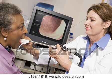Stock Photo - Doctor Performing Check-Up On Patient. Fotosearch
