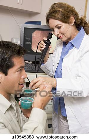 Stock Photo - Doctor Performing Check-Up On Patient. Fotosearch