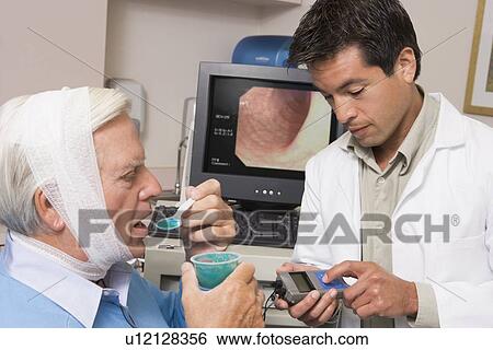 Doctor Performing Check-Up On Patient View Large Photo Image Stock Photograph - Doctor Performing Check-Up On Patient. Fotosearch