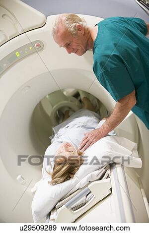 Stock Photo - Doctor With Patient As They Prepare For A Computerized Axial Tomography (CAT) Scan. Fotosearch