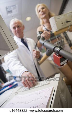 Stock Image - Doctor With Patient During Health Check. Fotosearch