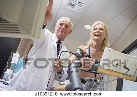 Doctor With Patient During Health Check View Large Photo Image Stock Photo - Doctor With Patient During Health Check. Fotosearch