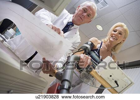 Doctor With Patient During Health Check View Large Photo Image Stock Photo - Doctor With Patient During Health Check. Fotosearch