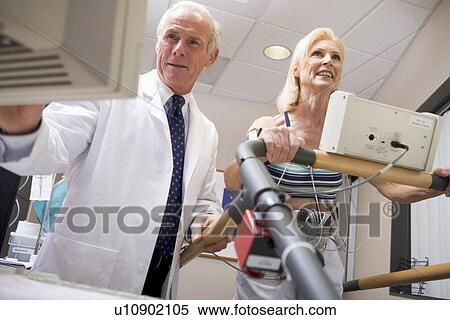 Stock Photography - Doctor With Patient During Health Check. Fotosearch