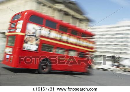 Stock Image - Double Decker Bus Driving Through The Streets Of London. Fotosearch