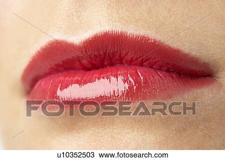 Stock Image - Extreme Close-Up Of Young Woman Wearing Red Lipstick. Fotosearch