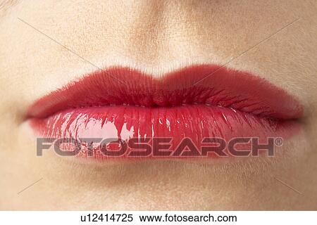Stock Photography - Extreme Close-Up Of Young Woman Wearing Red Lipstick. Fotosearch