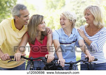 Stock Photo - Family Cycling Through A Park. Fotosearch