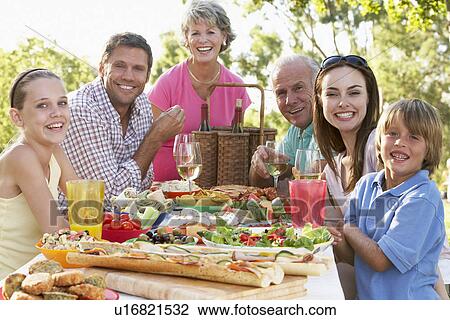 Stock Image - Family Dining Al Fresco. Fotosearch