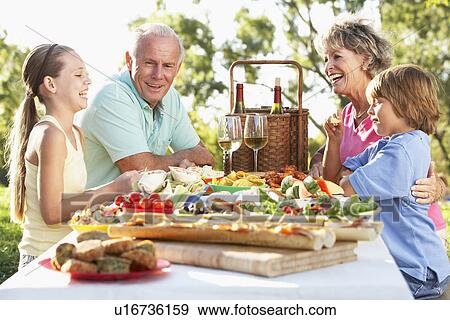 Stock Photo - Family Dining Al Fresco. Fotosearch