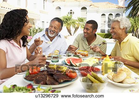 Stock Photo - Family Eating An Al Fresco Meal. Fotosearch