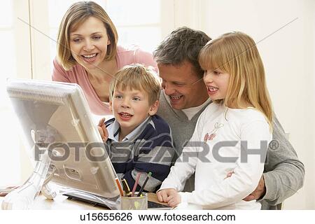 Stock Photograph - Family Group Using Computer. Fotosearch