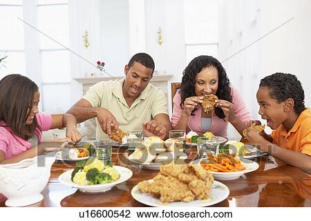 Stock Image - Family Having A Meal Together At Home. Fotosearch